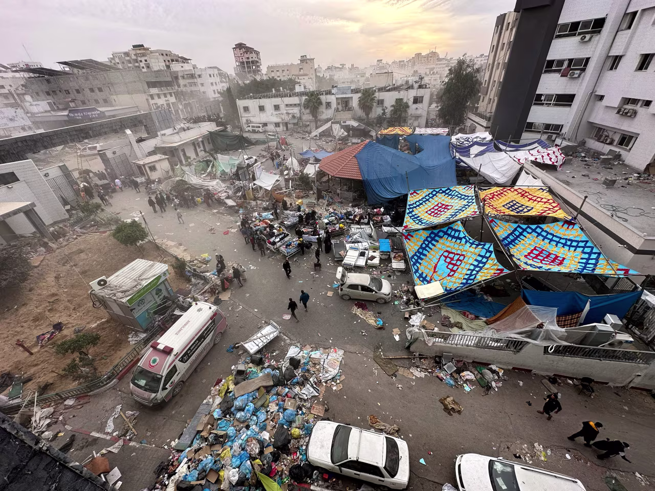 Palestinians inspect Al Shifa Hospital, which was raided by Israeli forces during its ground operation in Gaza City, on November 25.