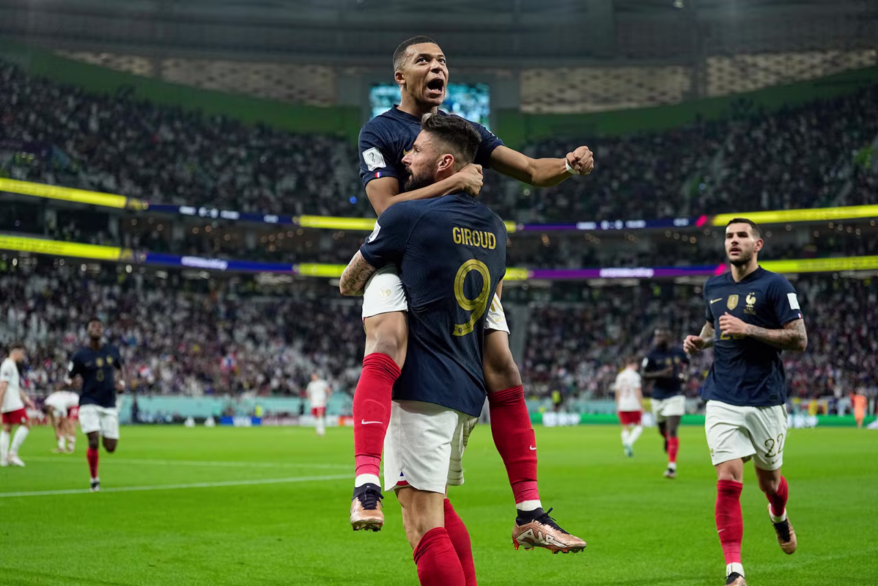 Kylian Mbappe celebrates after Olivier Giroud scored France’s first goal against Poland on Sunday. 