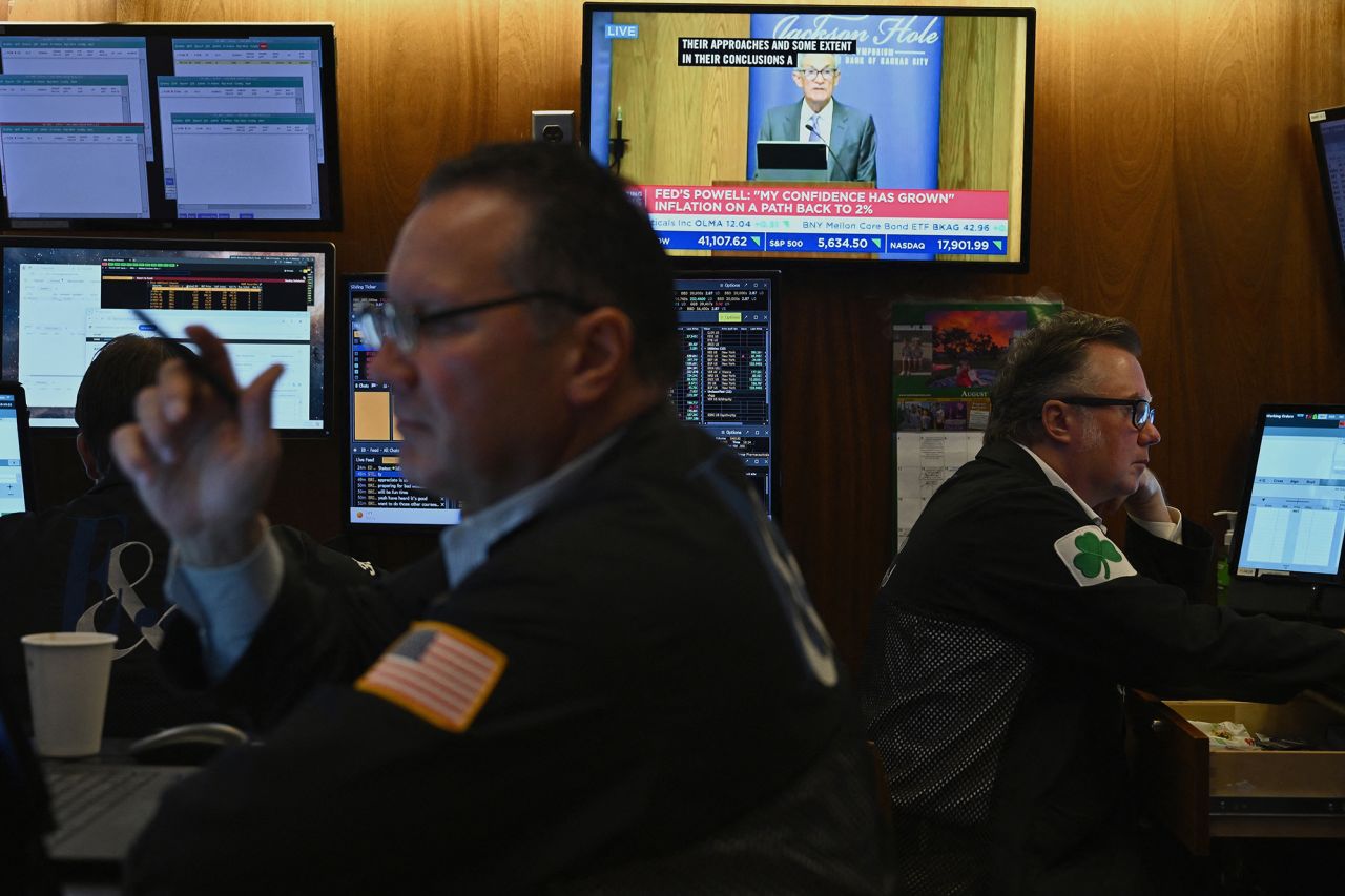 A television station broadcasts US Federal Reserve Chair Chair Jerome Powell speaking in Jackson Hole, Wyoming, on the floor of the New York Stock Exchange on August 23.