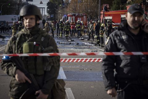 Emergency service personnel attend to the site of a blast on October 10, in Kyiv, Ukraine.
