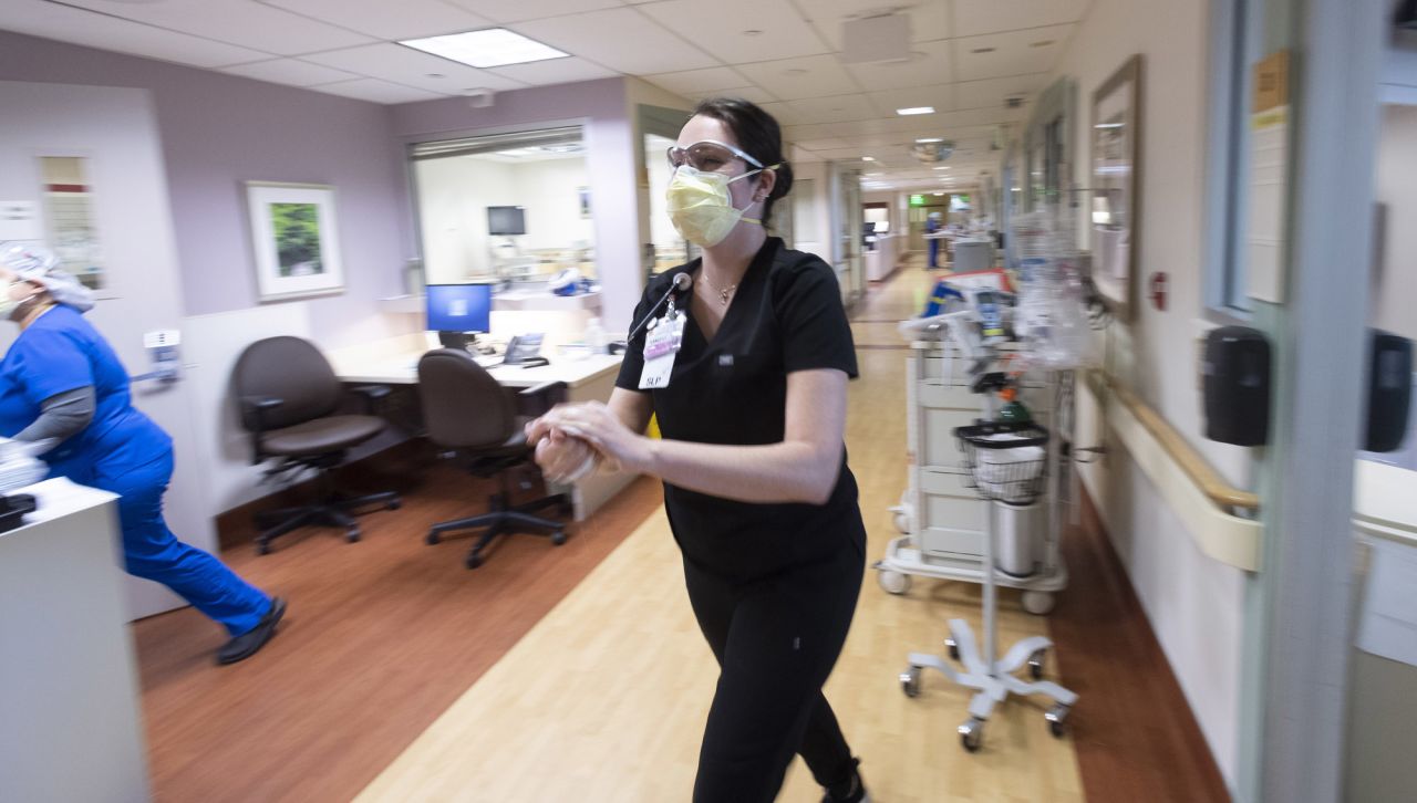 A staff member sanitizes her hands in the Critical Care Unit at St. Jude Medical Center in Fullerton, CA on Tuesday, December 1. 