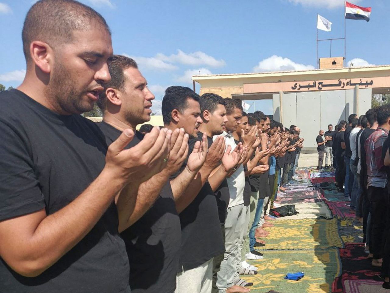 Egyptian volunteers gather in Rafah, Egypt, on Wednesday for a funeral prayer for those killed in the blast at the al-Ahli hospital in Gaza.