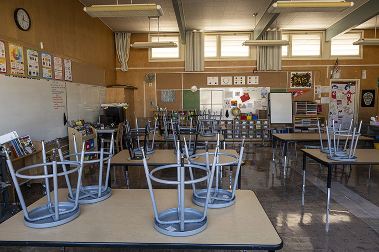 Stools stacked on desks inside an empty classroom at Collins Elementary School in Pinole, California, on December 30, 2020. 