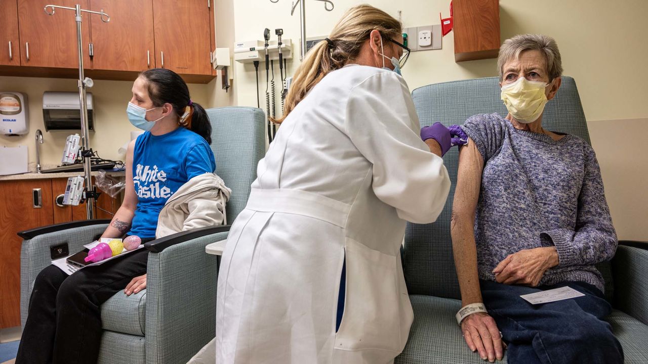 A cancer patient receives her COVID-19 vaccine in an oncology unit at the James Graham Brown Cancer Center on April 2, in Louisville, Kentucky. 