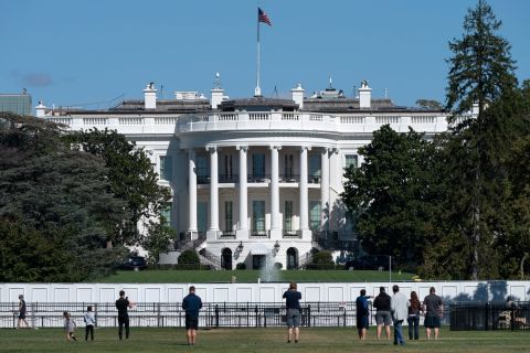 People take pictures of the White House on October 8.