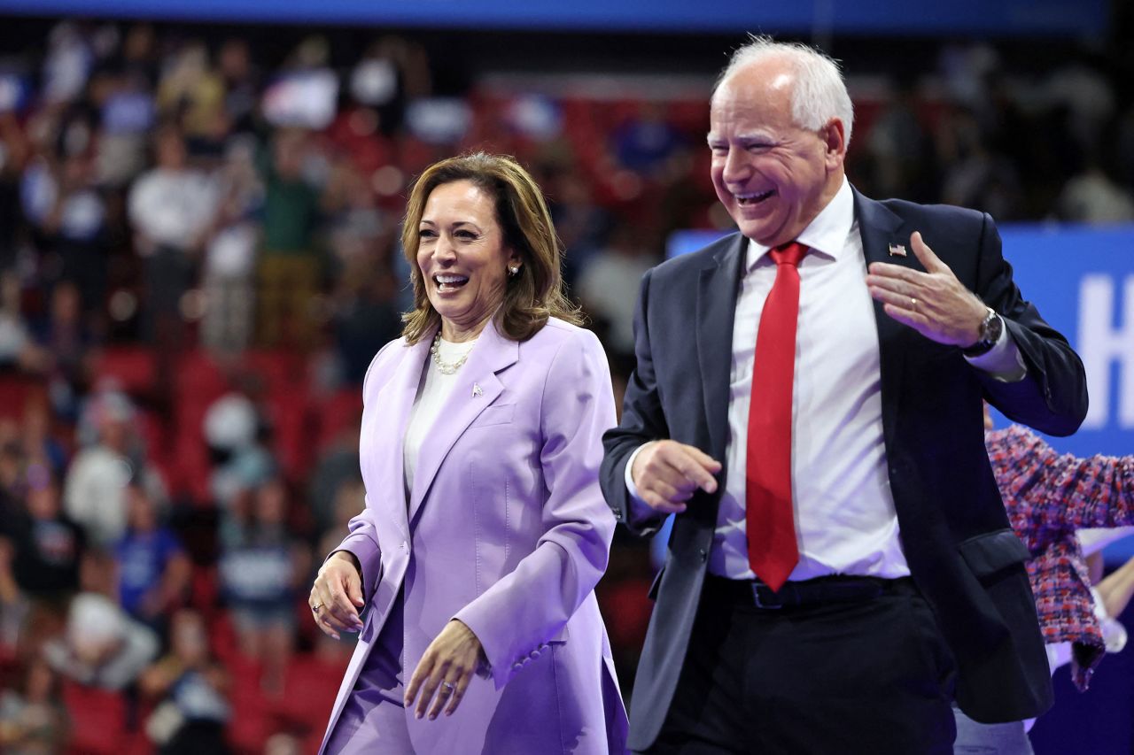 Vice President Kamala Harris and Minnesota Gov. Tim Walz greet the crowd at a campaign rally in Las Vegas on Saturday.