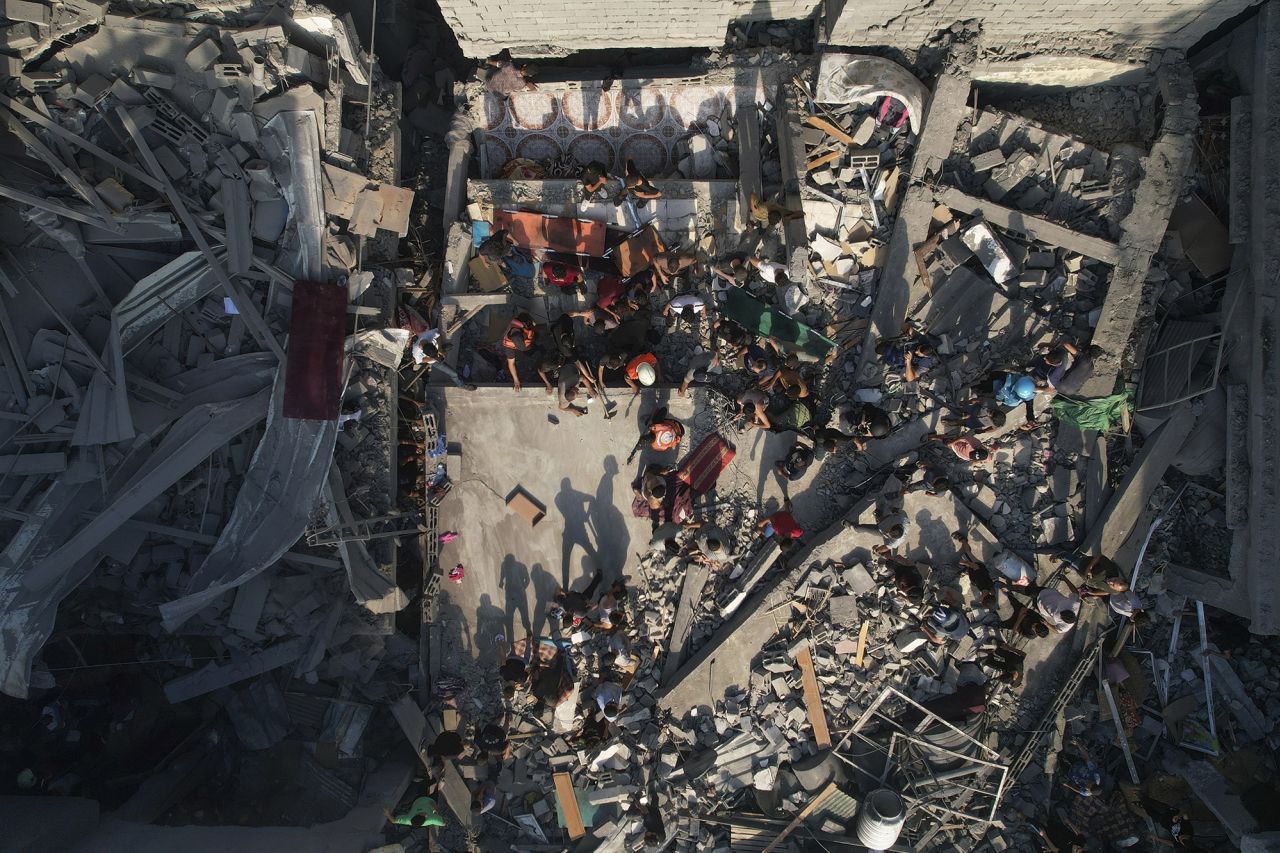 Palestinians inspect the rubble of buildings hit by an Israeli airstrike at Al Shati Refugee Camp, Gaza, on October 12.