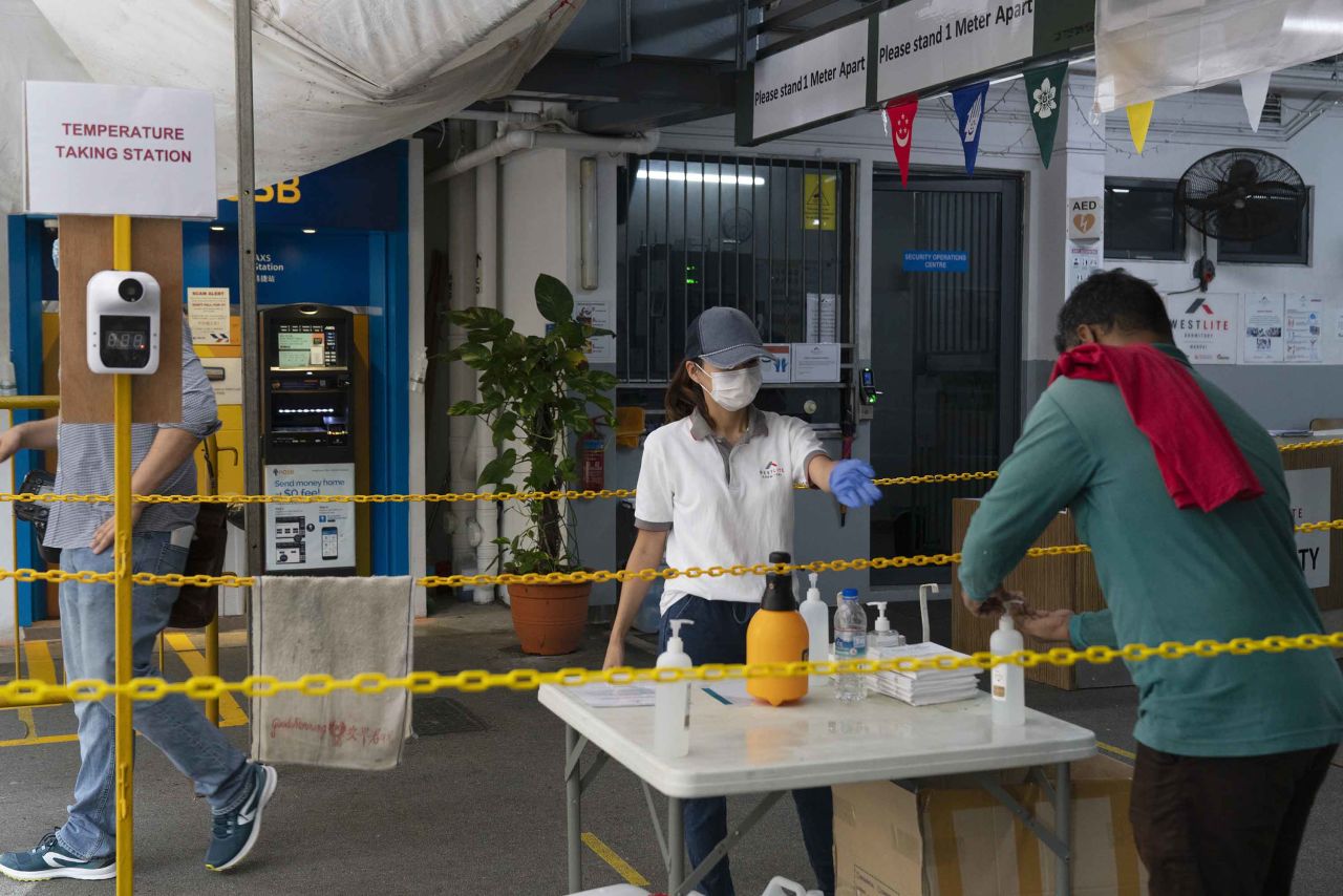 A worker uses hand sanitizer at the entrance to the Westlite Mandai worker dormitory in Singapore, in August.