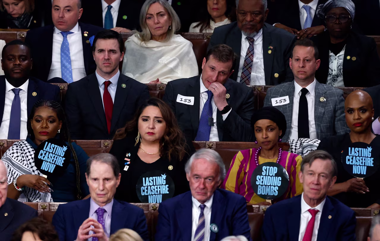 Members of Congress hold signs calling for a ceasefire in the ongoing conflict between Israel and Hamas.