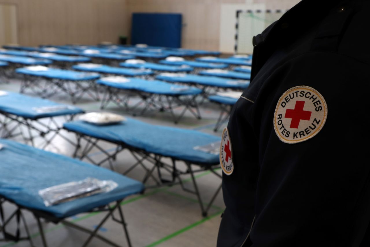 A German Red Cross member stands in front of camp beds at a medical assessment center at Frankfurt airport on the eve of the arrival of German citizens evacuated from the Chinese city of Wuhan on January 31, 2020.