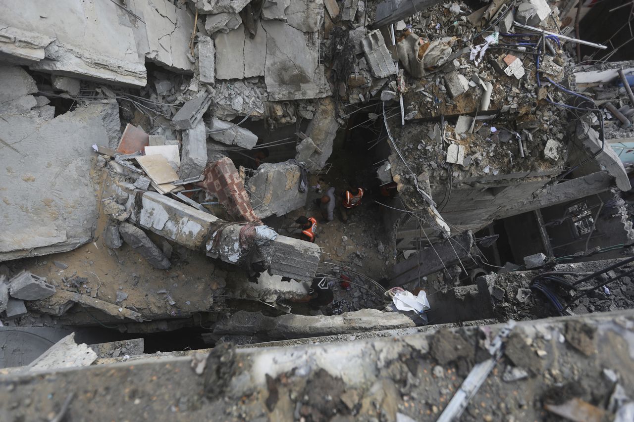 Palestinians inspect the area after an Israeli strike on a residential building in Rafah, Gaza, on May 7.