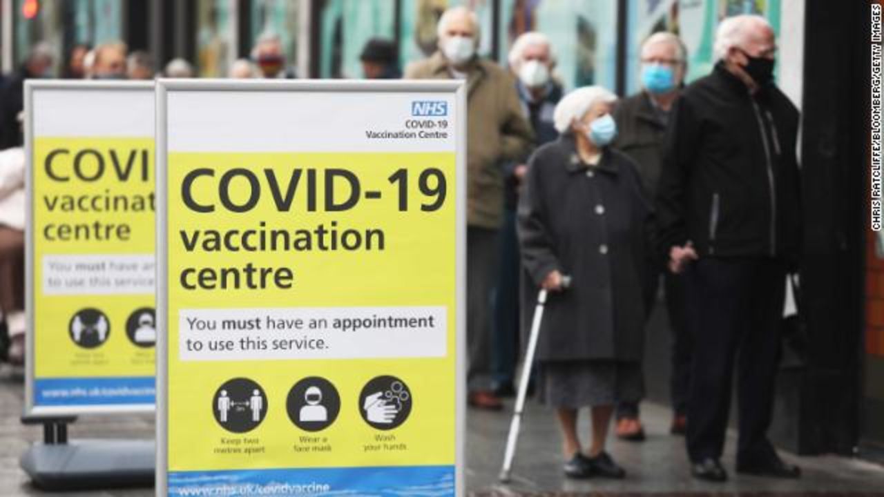 Visitors queue before receiving the AstraZeneca vaccine at a closed down Debenhams department store, in Folkestone on Wednesday