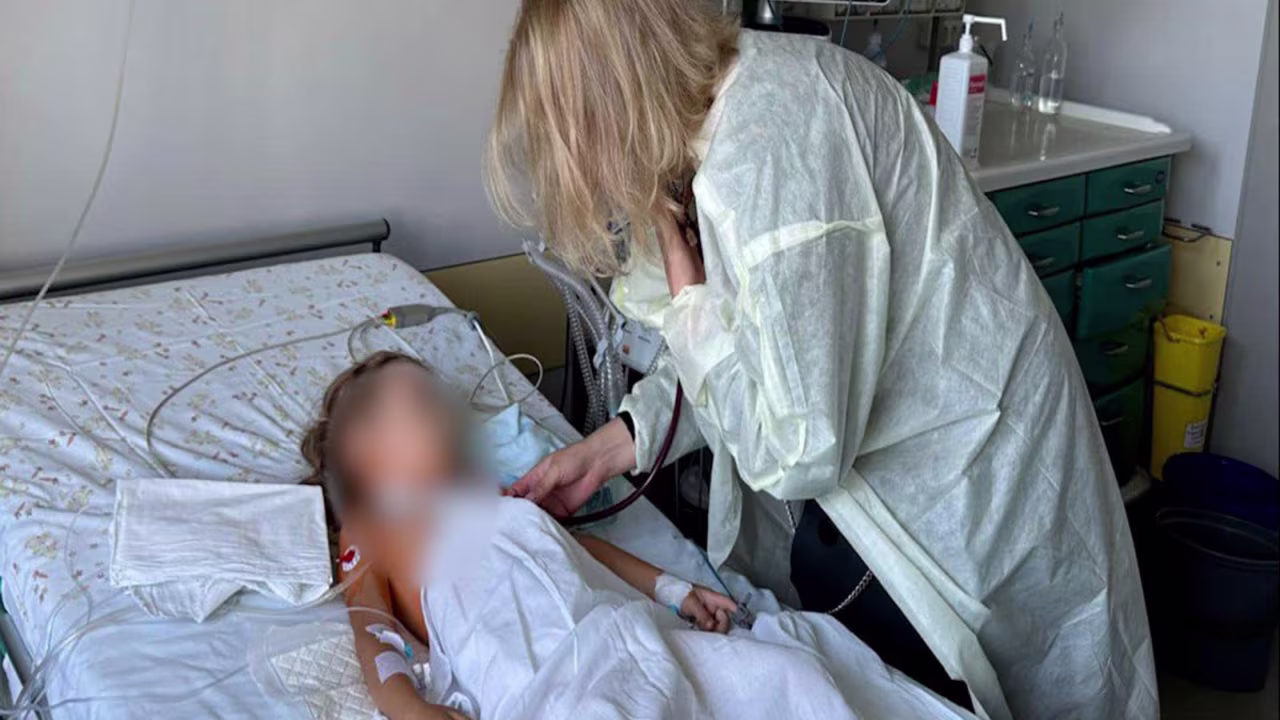 The mother of the donor — a 4-year-old boy — visits the 6-year-old girl who received his heart.  