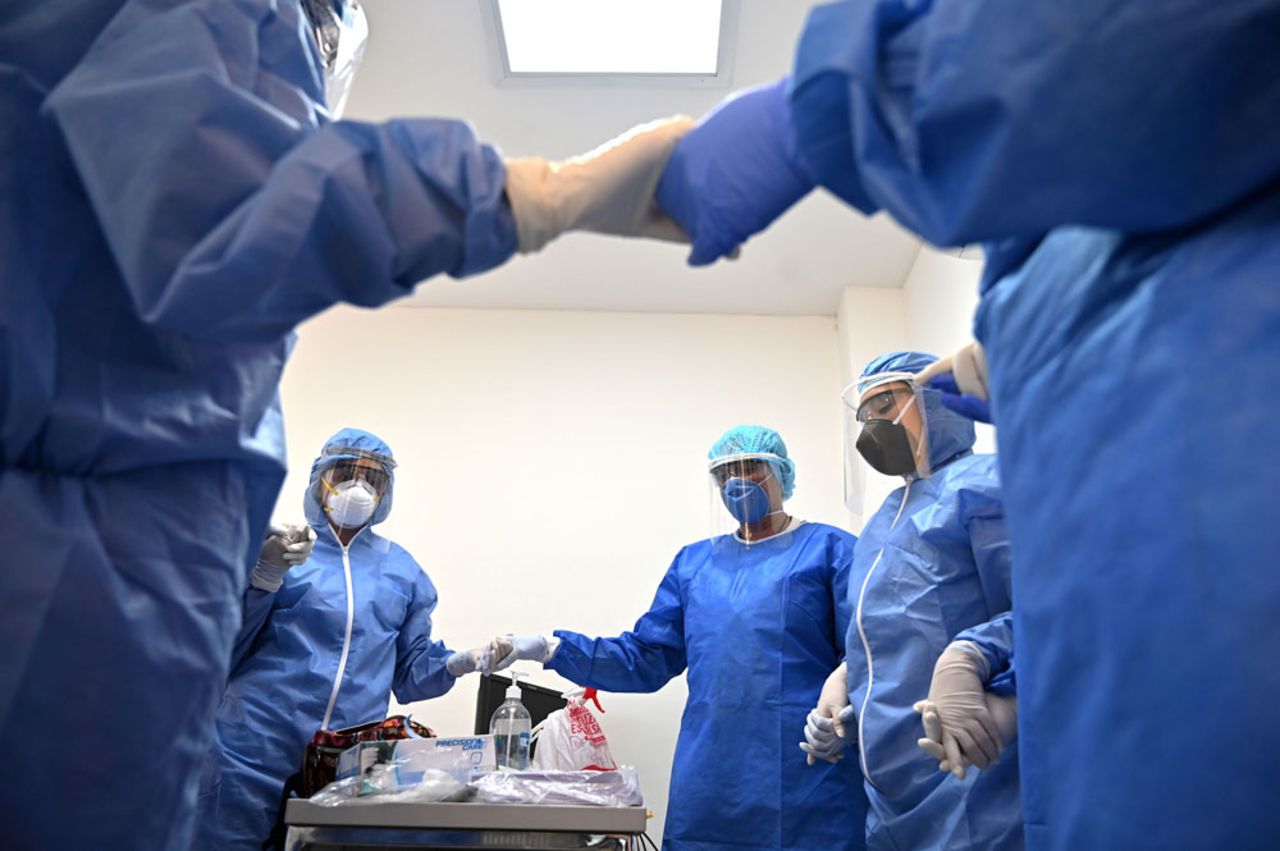 Health workers pray before going out for coronavirus check-ups in Cali, Colombia, on April 20.