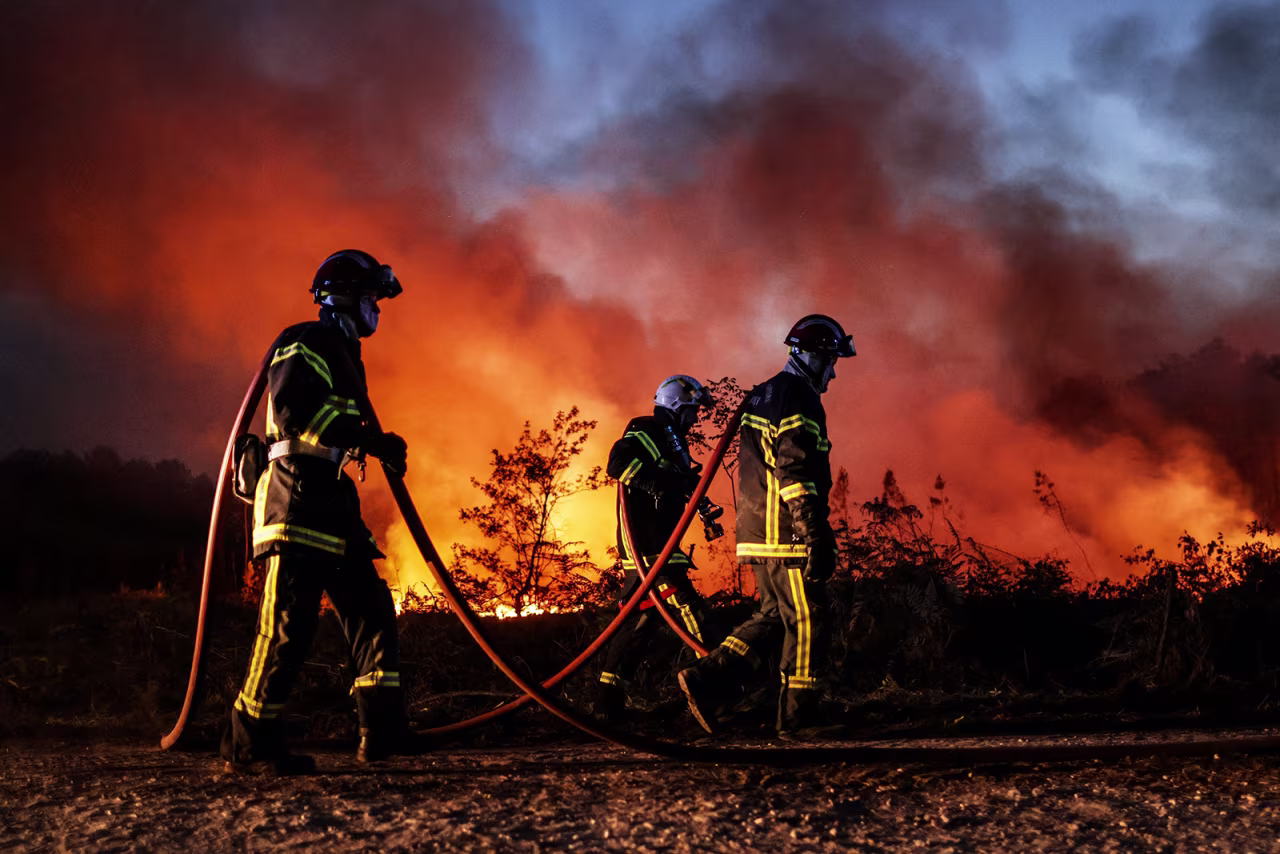 Firefighters try to control a forest fire in Louchats, in the Gironde area of southwestern France, on July 17.