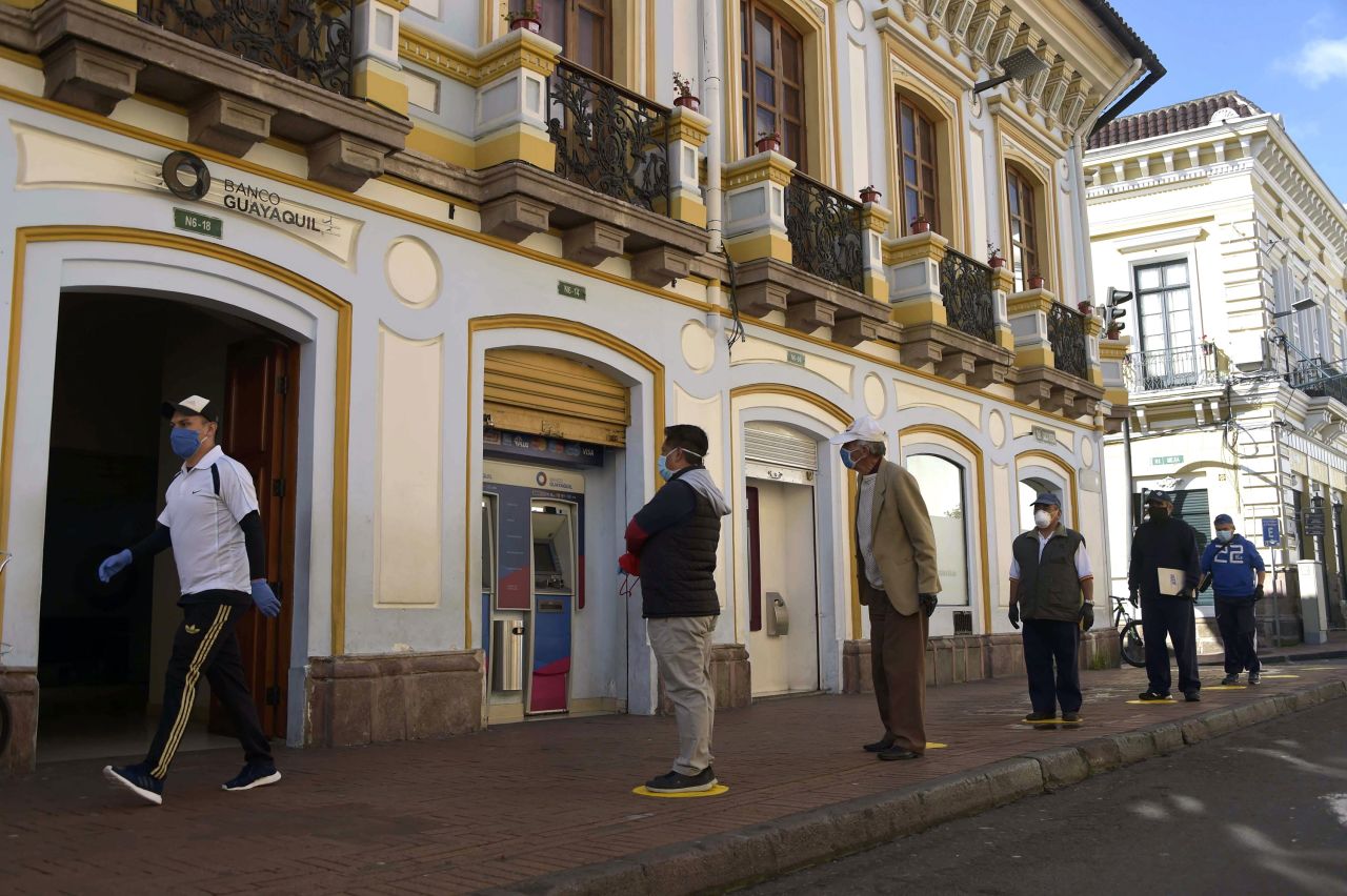 People queue outside a bank in downtown Quito, Ecuador, on April 22.