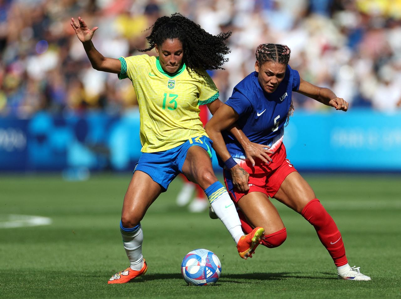 Brazil’s Yasmim and USA’s Trinity Rodman fight for the ball during the first half of the women’s soccer gold medal match on August 10. 