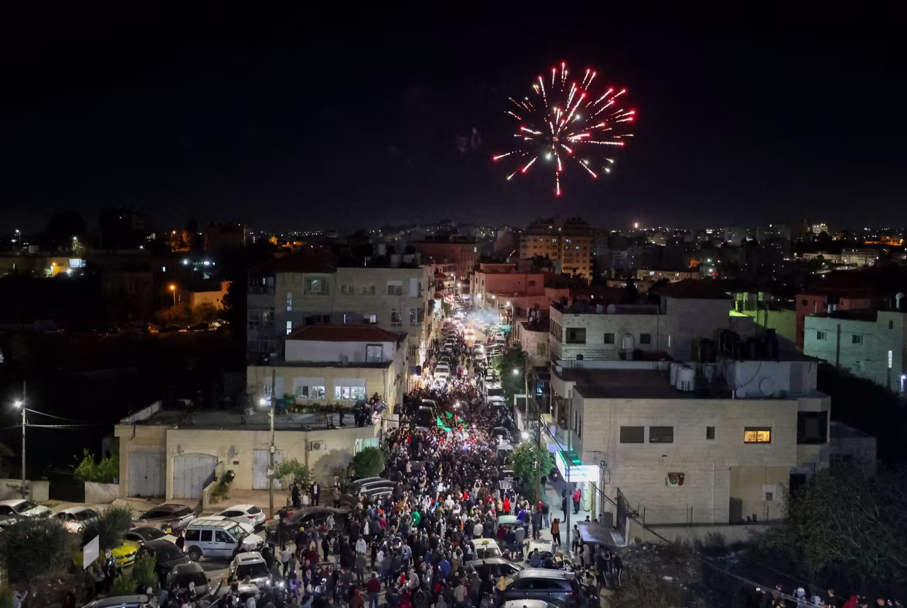 Fireworks streak across the sky as Palestinian prisoners that were released from the Israeli Ofer military facility are paraded in Beitunia, in the occupied West Bank, on Friday. 
