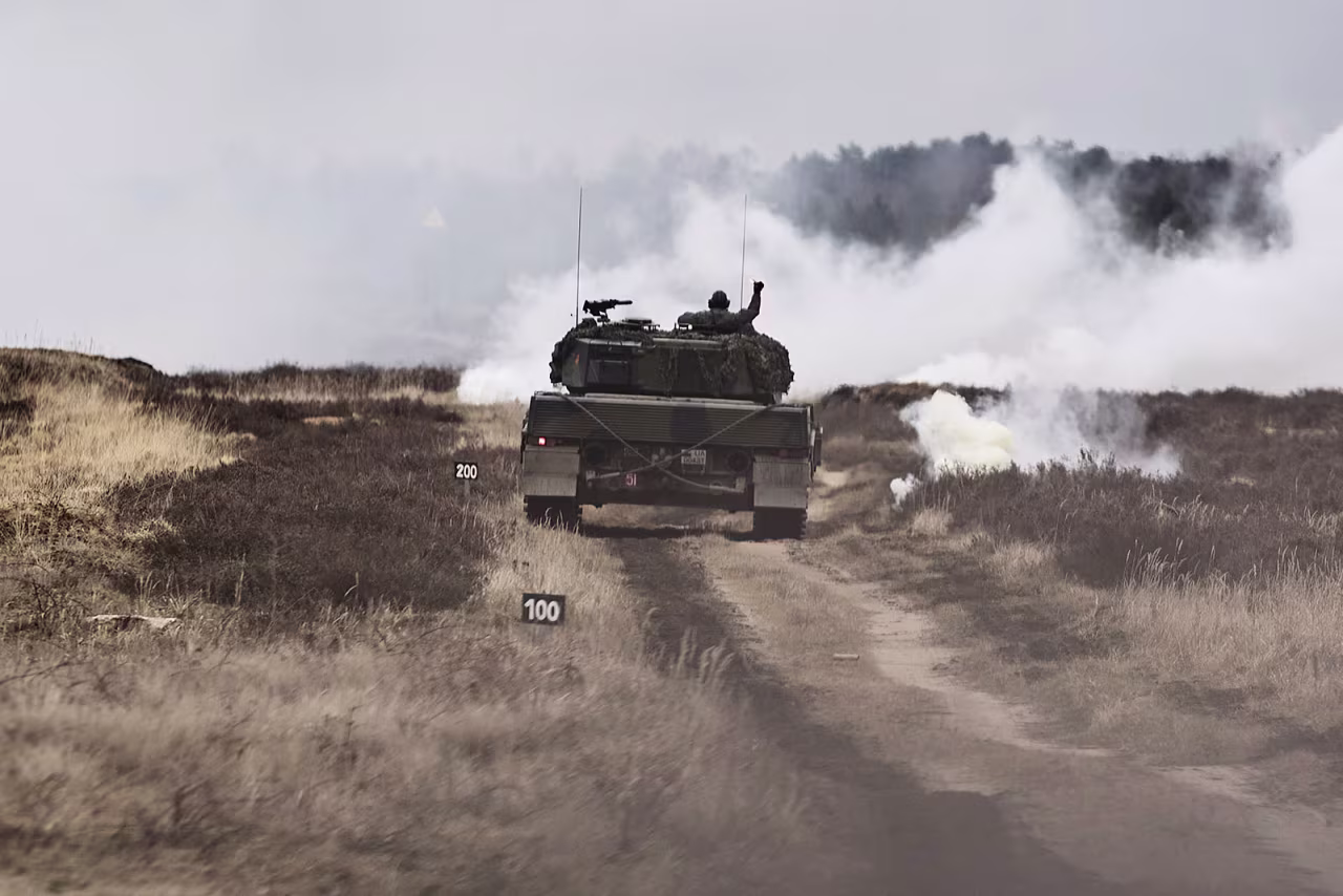 A Leopard 2 A4 tank rolls down a path at the training center where Polish Army soldiers train personnel from the Armed Forces of Ukraine on Monday. 