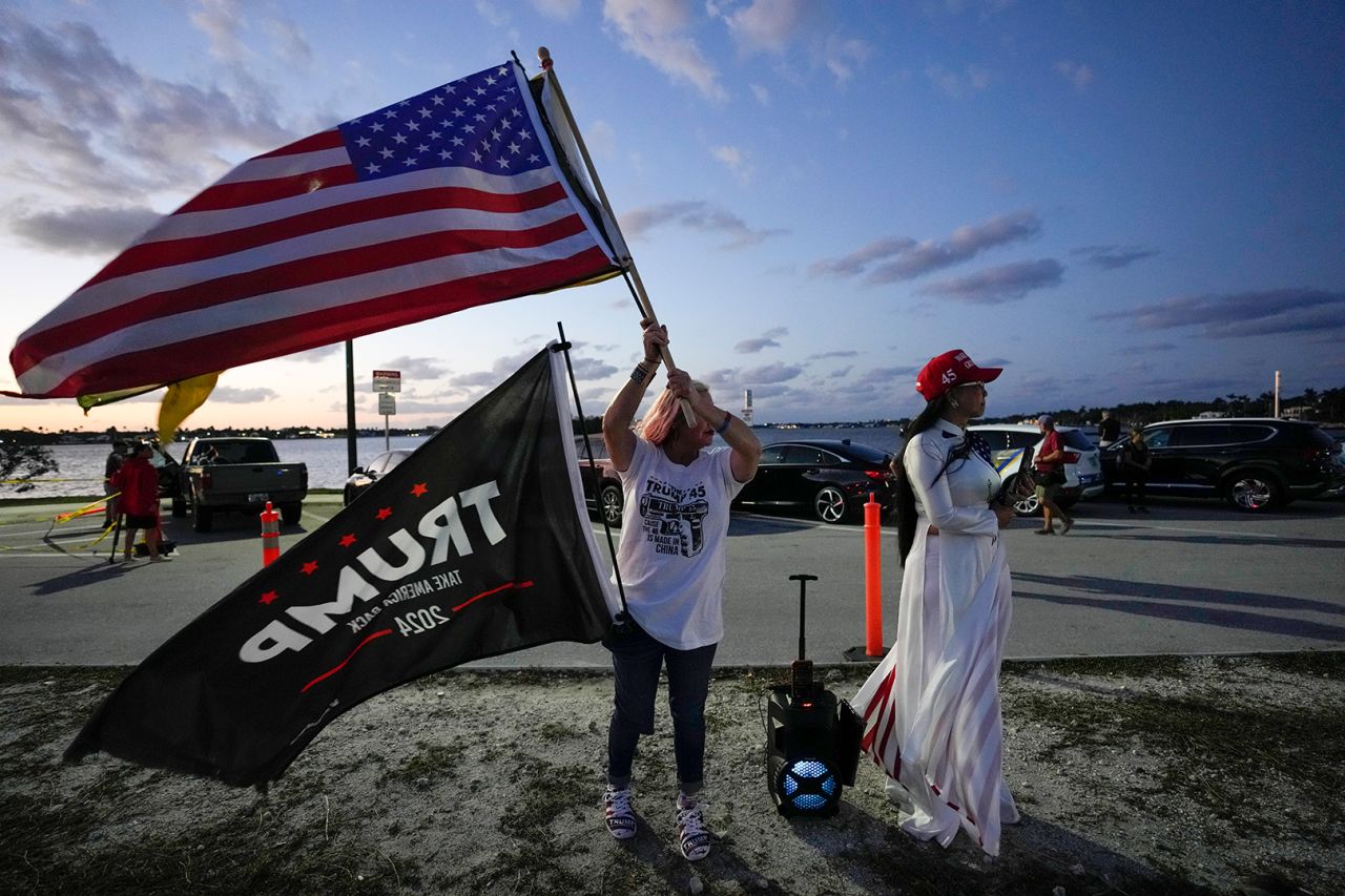 Trang Le of Orlando, right, and Maria Korynsel of North Palm Beach show their support for former President Donald Trump after the news broke that the former president was indicted by a Manhattan grand jury on Thursday.