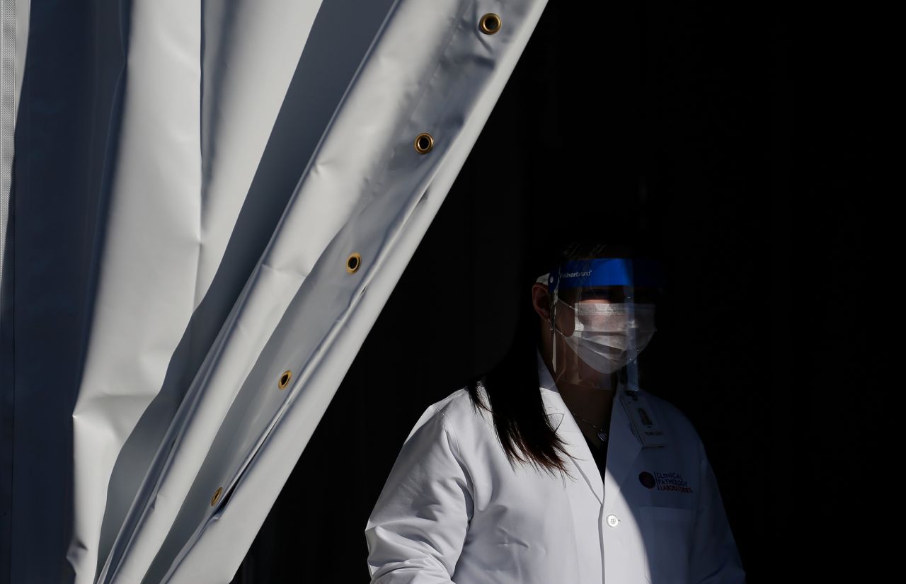 A worker with Clinical Pathology Laboratories waits for patients at a drive-through coronavirus testing site Tuesday, March 24, in Las Vegas. 