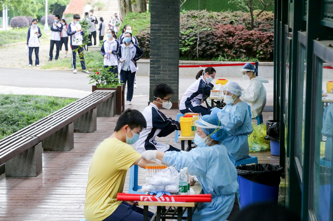 Students in grade three of Hubei Wuchang Experimental High School have their blood taken for nucleic acid and serum antibody tests on April 30, in preparation for classes to resume in Wuhan, China.