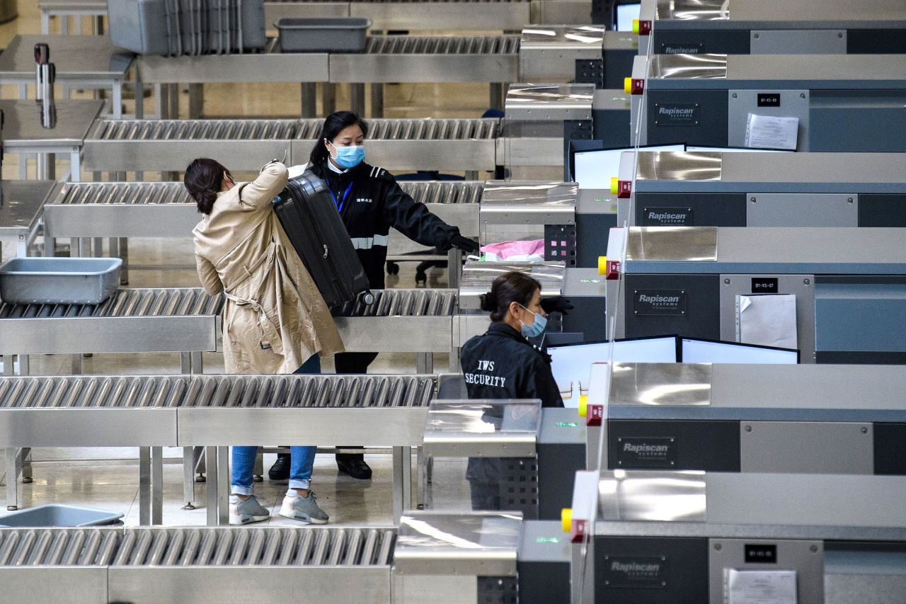 Security personnel wear face masks inside the high-speed railway station connecting Hong Kong to mainland China on January 28, 2020