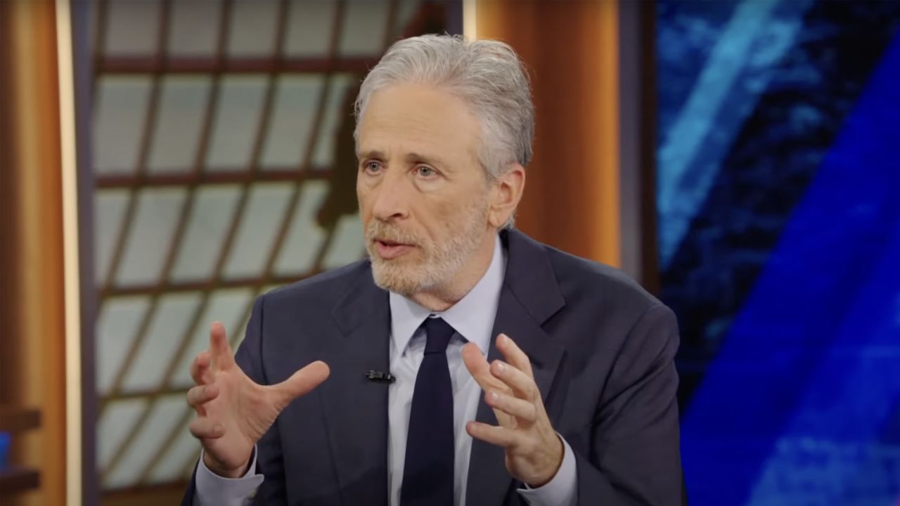 Jon Stewart is pictured in a screengrab taken from a segment of The Daily Show during his interview with Federal Trade Commission Chair Lina Khan.