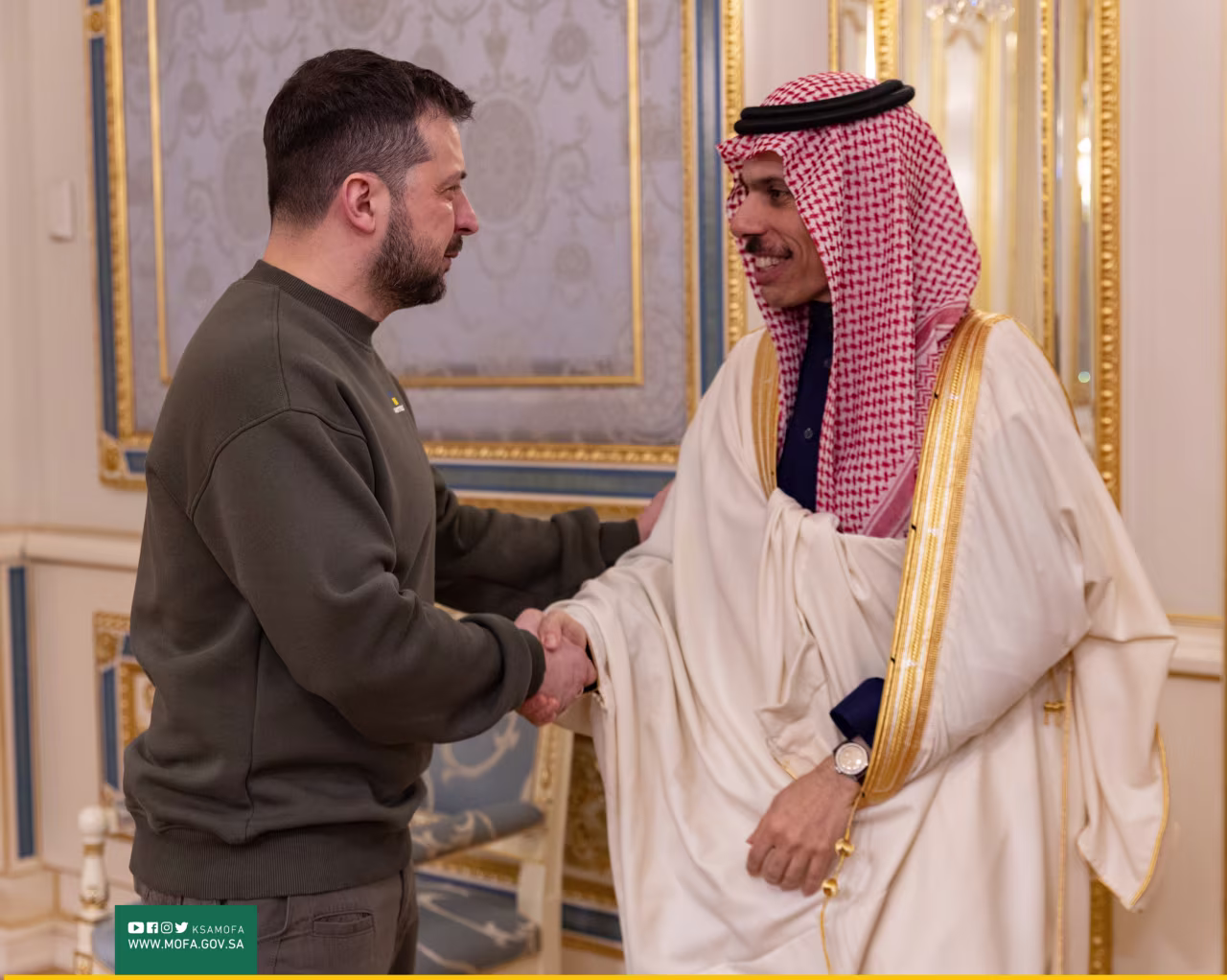 Ukrainian President Volodymyr Zelensky, left, shakes hands with Saudi Arabia's Prince Faisal bin Farhan Al Saud, on Sunday.