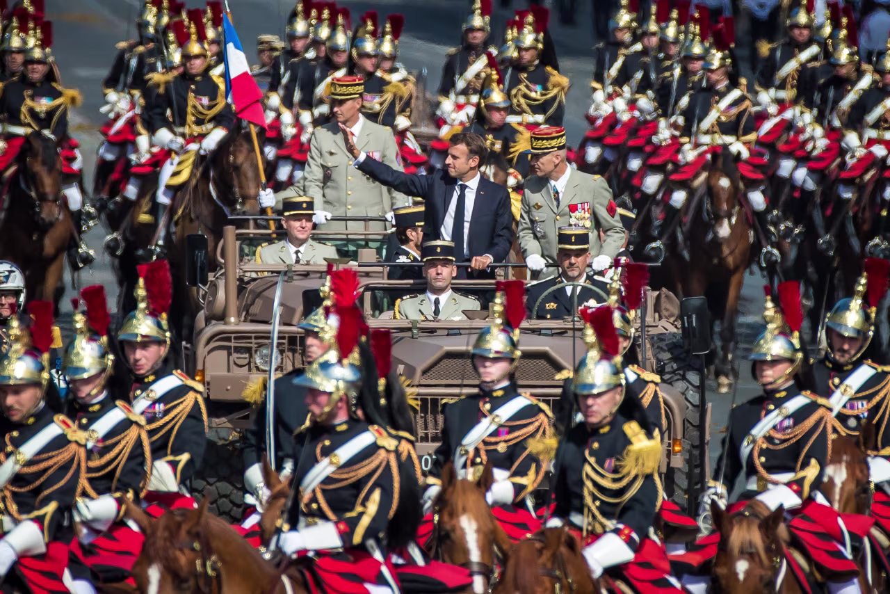 French President Emmanuel Macron, center left, stands next to Chief of Staff Thierry Burkhard, center right, during the Bastille Day parade on the Champs-Elysees avenue in Paris, France, on July 14.