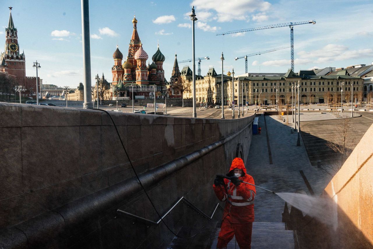 A municipal worker disinfects a bridge near the Kremlin in Moscow on April 12.