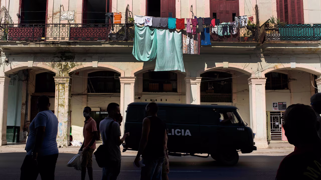 A police vehicle patrols through Old Havana, Cuba, Monday, July 12, the day after protests against food shortages and high prices amid the coronavirus crisis. 