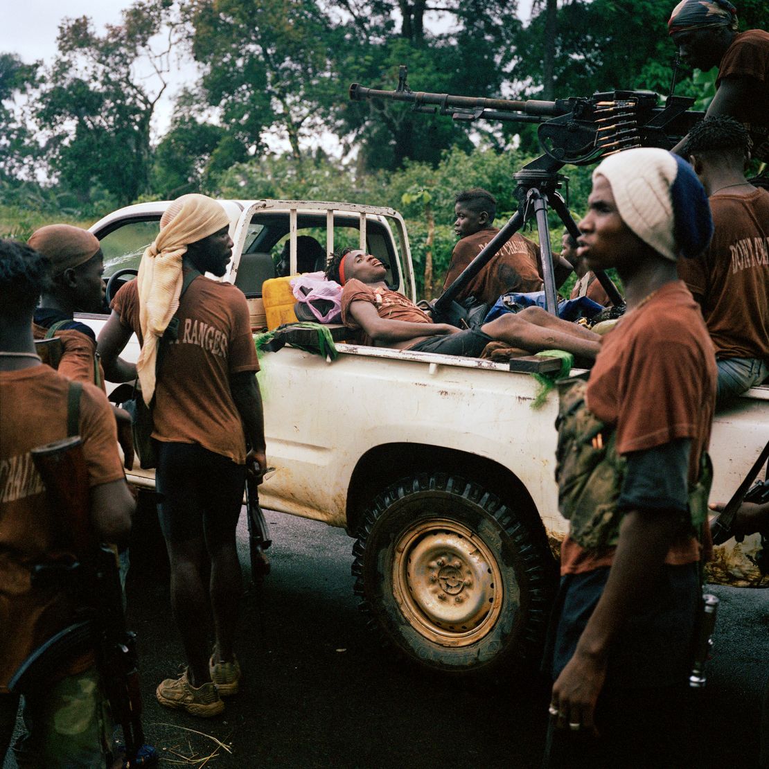 A casualty from an ambush lies in the back of a 'technical' during the push on Liberia's capital Monrovia in June 2003. 