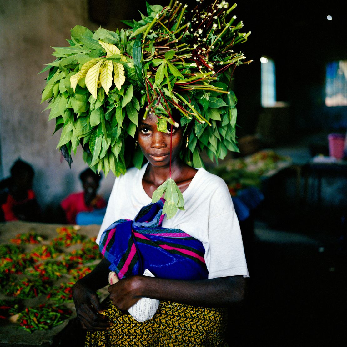 A woman brings cassava leaves into the central market area of Tubmanberg, Liberia in May 2003. 
