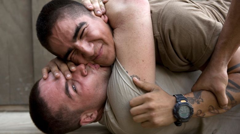 Bobby kisses Cortez udring a play fight at the barracks of Second Platoon at the Korengal Outpost.
Korengal Valley, Kunar Province, Afghanistan.
June 2008.