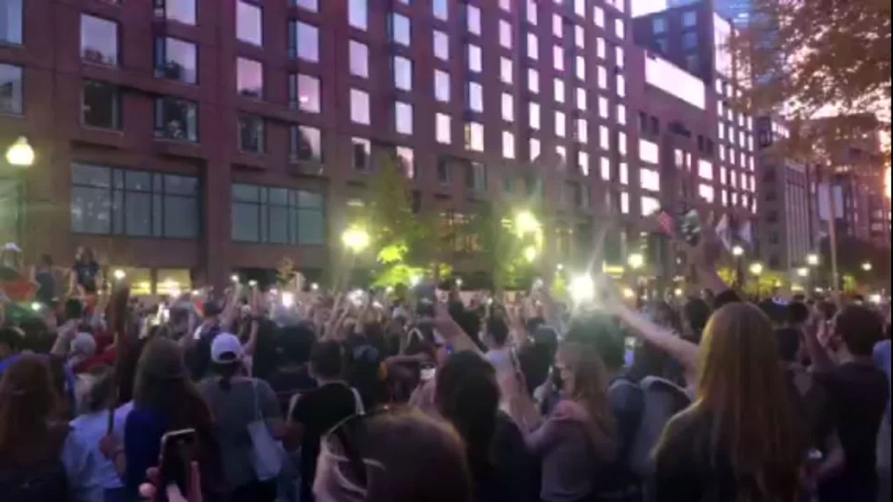 A crowd sings "We Are the Champions" on Saturday in Boston, Massachusetts.