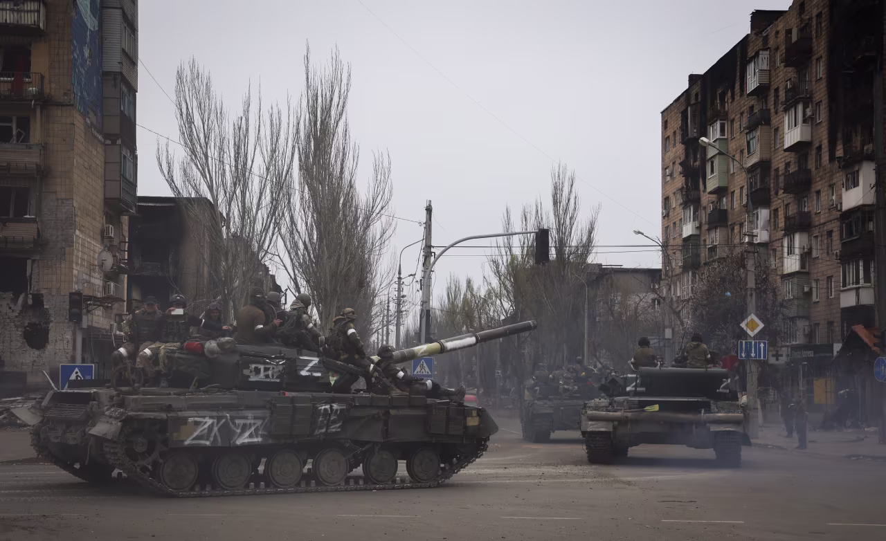 Russian military vehicles move in an area controlled by Russian-backed separatist forces in Mariupol, on Saturday, April 23.