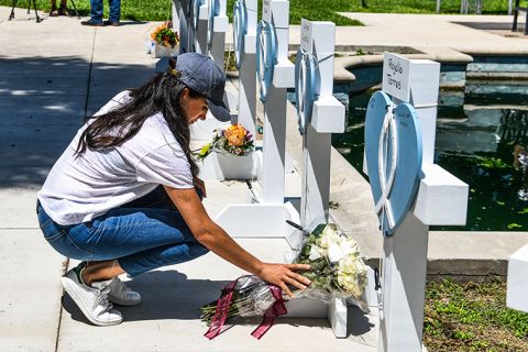 Meghan, Duchess of Sussex, places flowers at a makeshift memorial outside Uvalde County Courthouse in Uvalde, Texas, on Thursday, May 26.