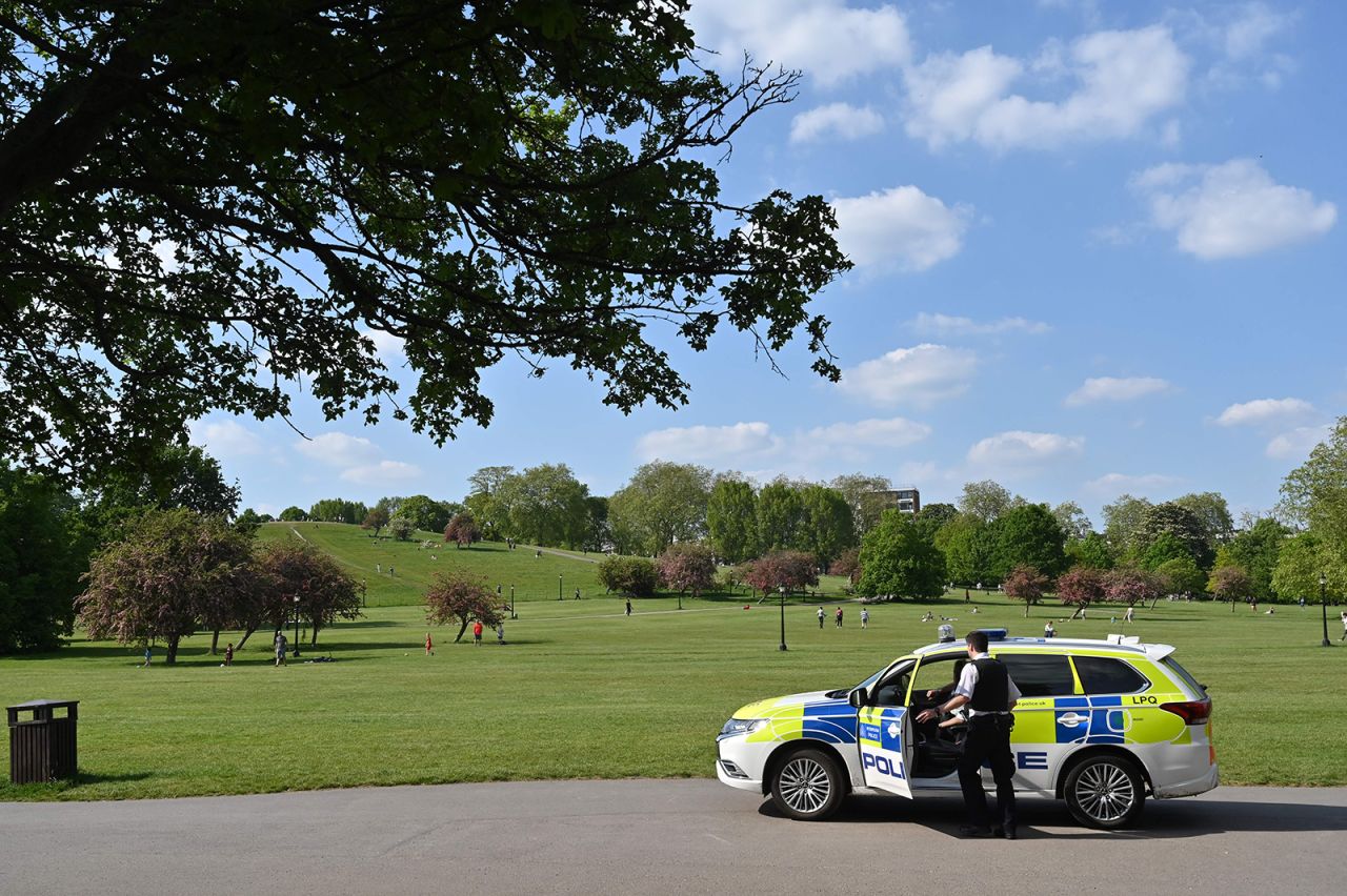 Police officers patrol Primrose Hill in London on Thursday, May 7, as life continues in Britain under a nationwide lockdown to slow the spread of the novel coronavirus.