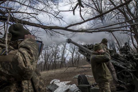 Ukrainian servicemen fire artillery towards Russian positions near the Bakhmut frontline on Friday.