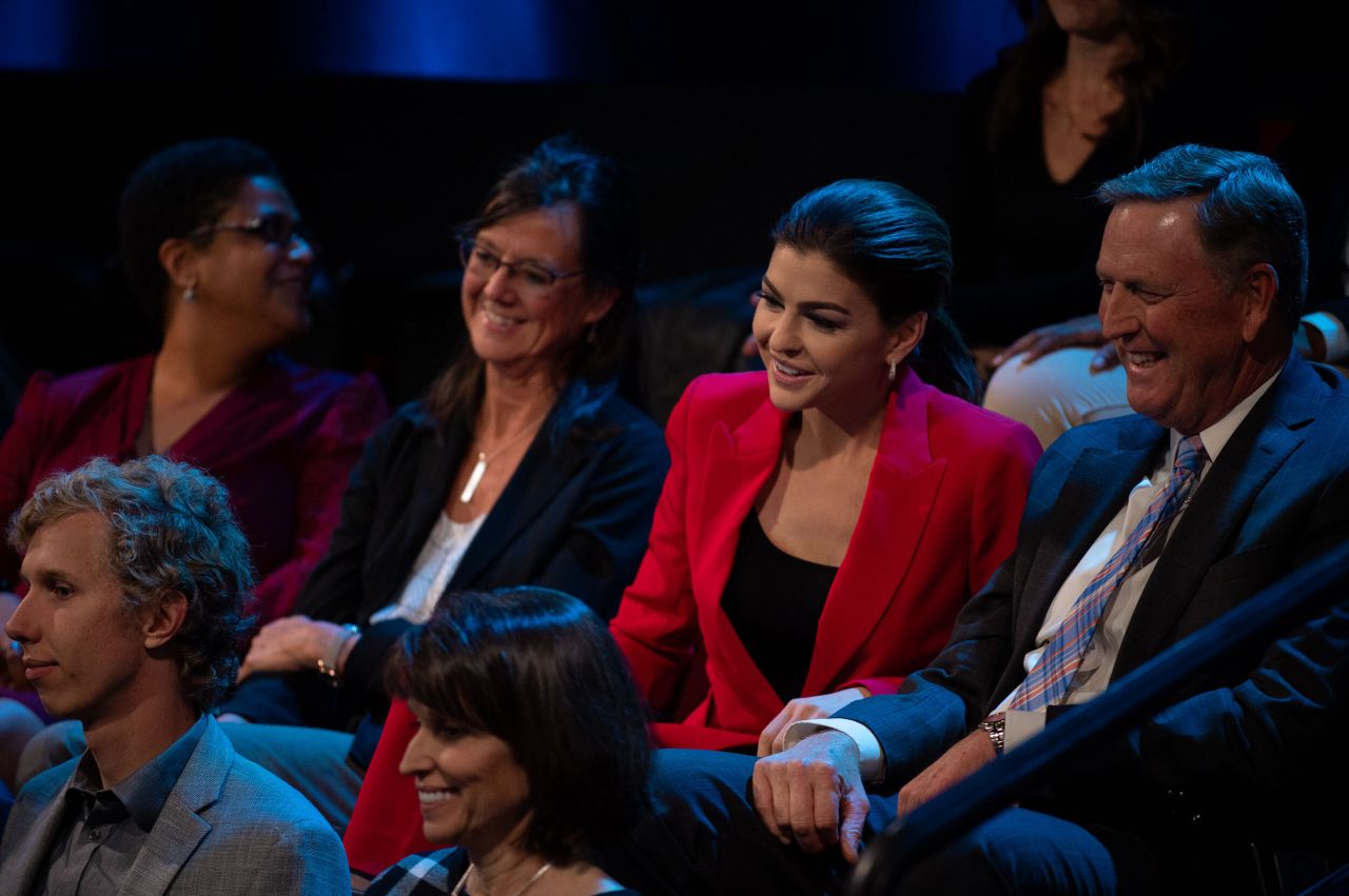 Florida first lady Casey DeSantis reacts as her husband answers a question.