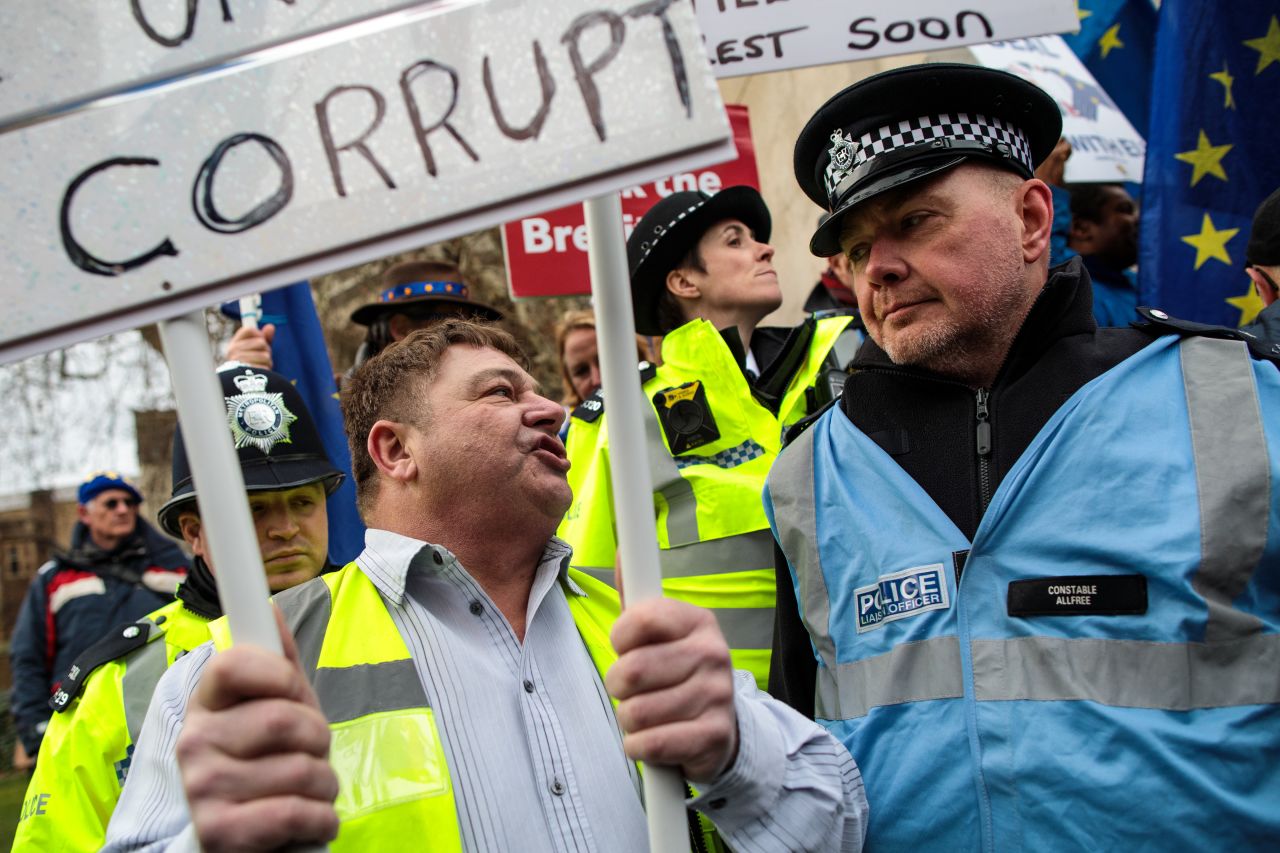 A Pro-Brexit demonstrator chants near an officer on duty hours before lawmakers vote on seven amendments to the UK Prime Minister's Brexit deal. 