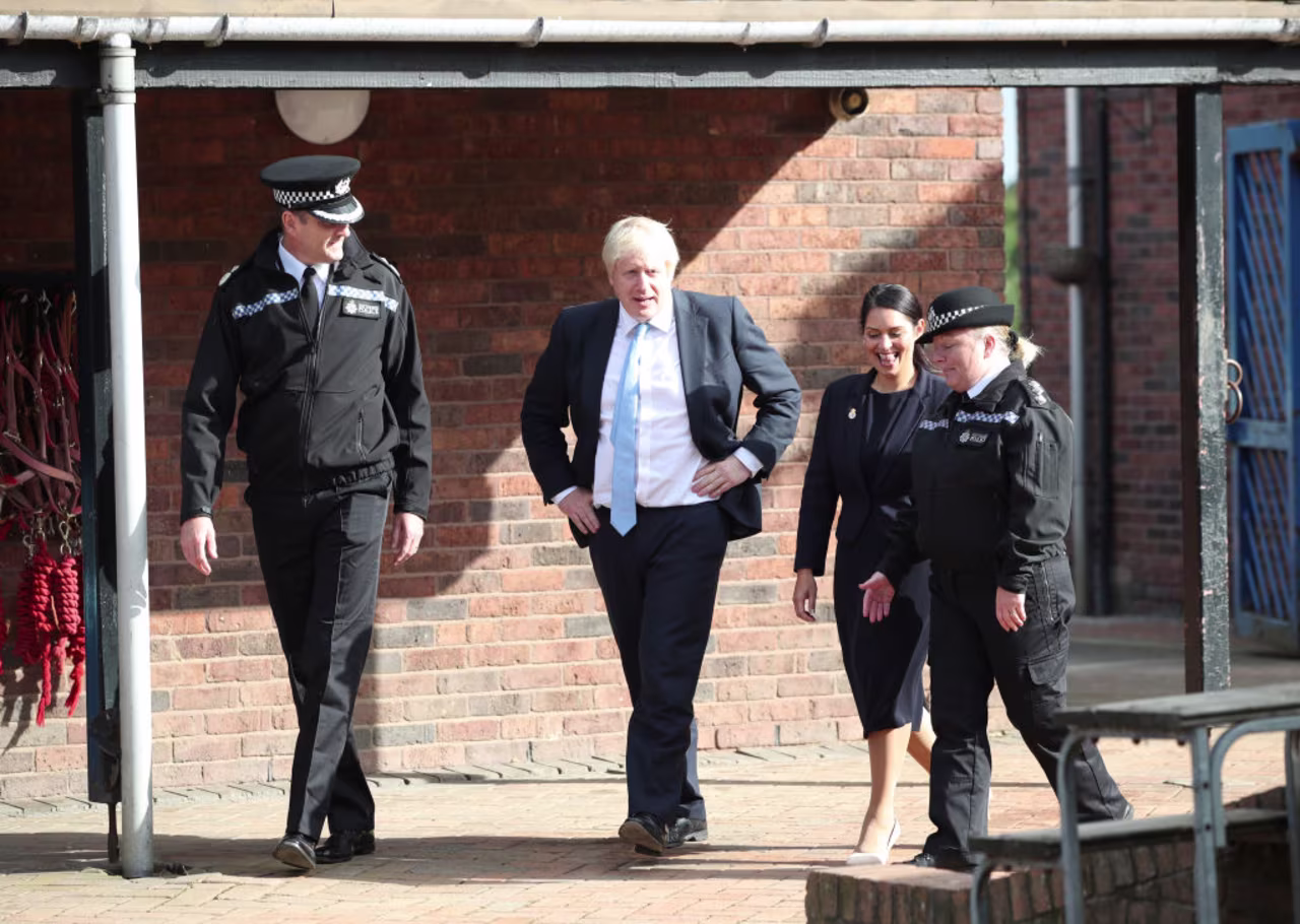 Prime Minister Boris Johnson with Home Secretary Priti Patel speak to police officers in Wakefield.