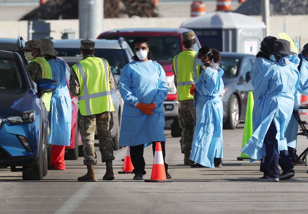 Health care workers check in people at a testing site setup by the the Florida National Guard, in Miami Gardens, Florida, on March 30.