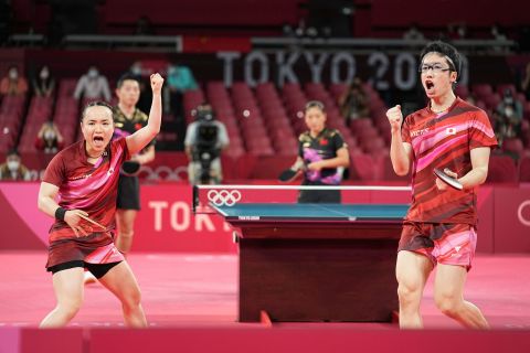 Japan's Mizutani Jun and Mima Ito react during their table tennis mixed doubles gold medal match against China on July 26.