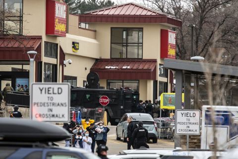Shoppers are escorted out of a King Soopers grocery where a gunman opened fire on March 22 in Boulder, Colorado.