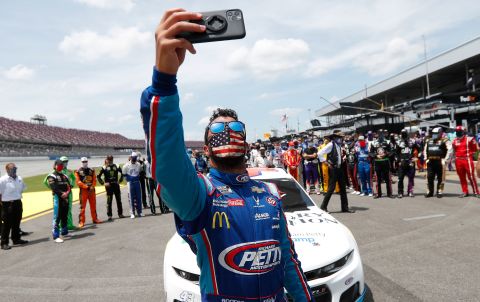 Bubba Wallace takes a selfie of himself and other drivers that pushed his car to the front in the pits of the Talladega Superspeedway prior to the start of the NASCAR Cup Series race on June 22 in Talladega, Alabama.