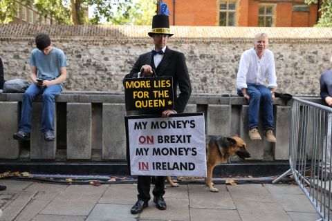 Another activist dressed up as Jacob Rees-Mogg.