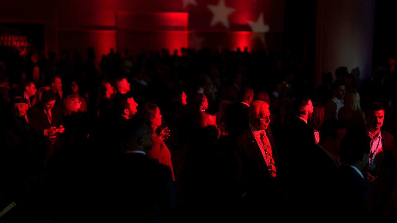 People gather before Florida Republican Gov. Ron DeSantis speaks to supporters at an election night party in Tampa. CNN projects DeSantis will win a second term.