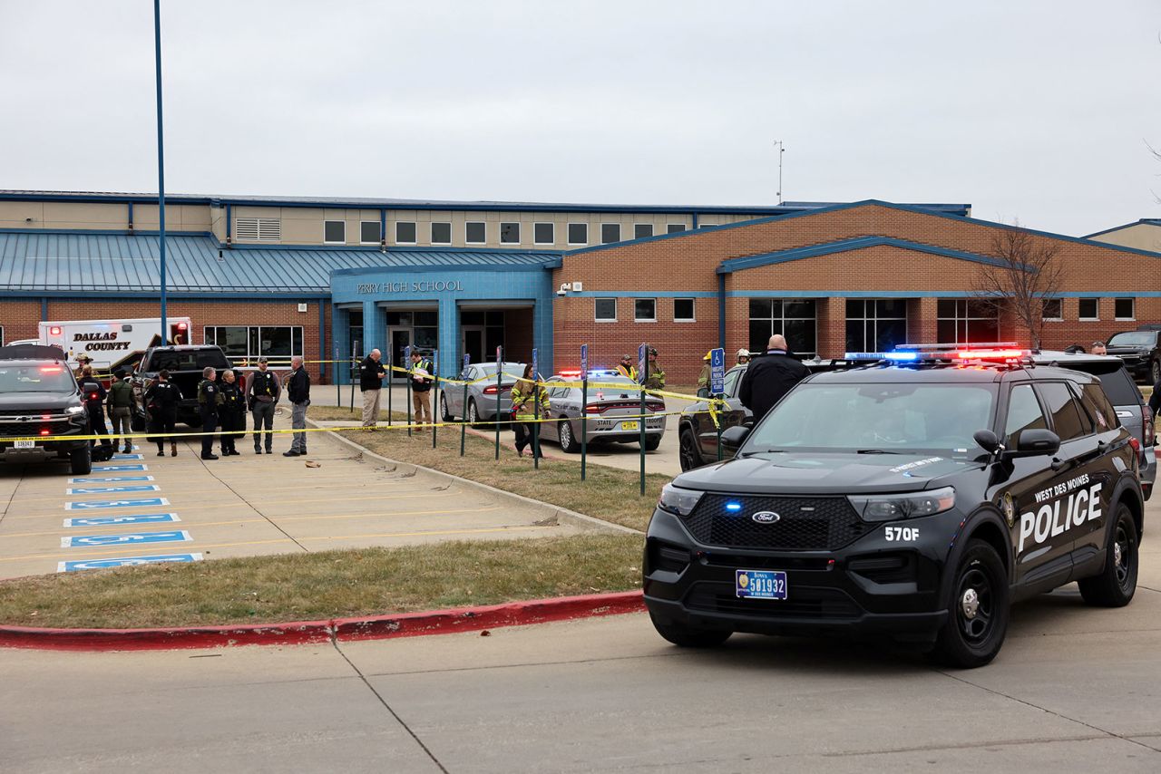 Law enforcement officers work at the scene of a shooting at Perry High School in Perry, Iowa, on Thursday. 